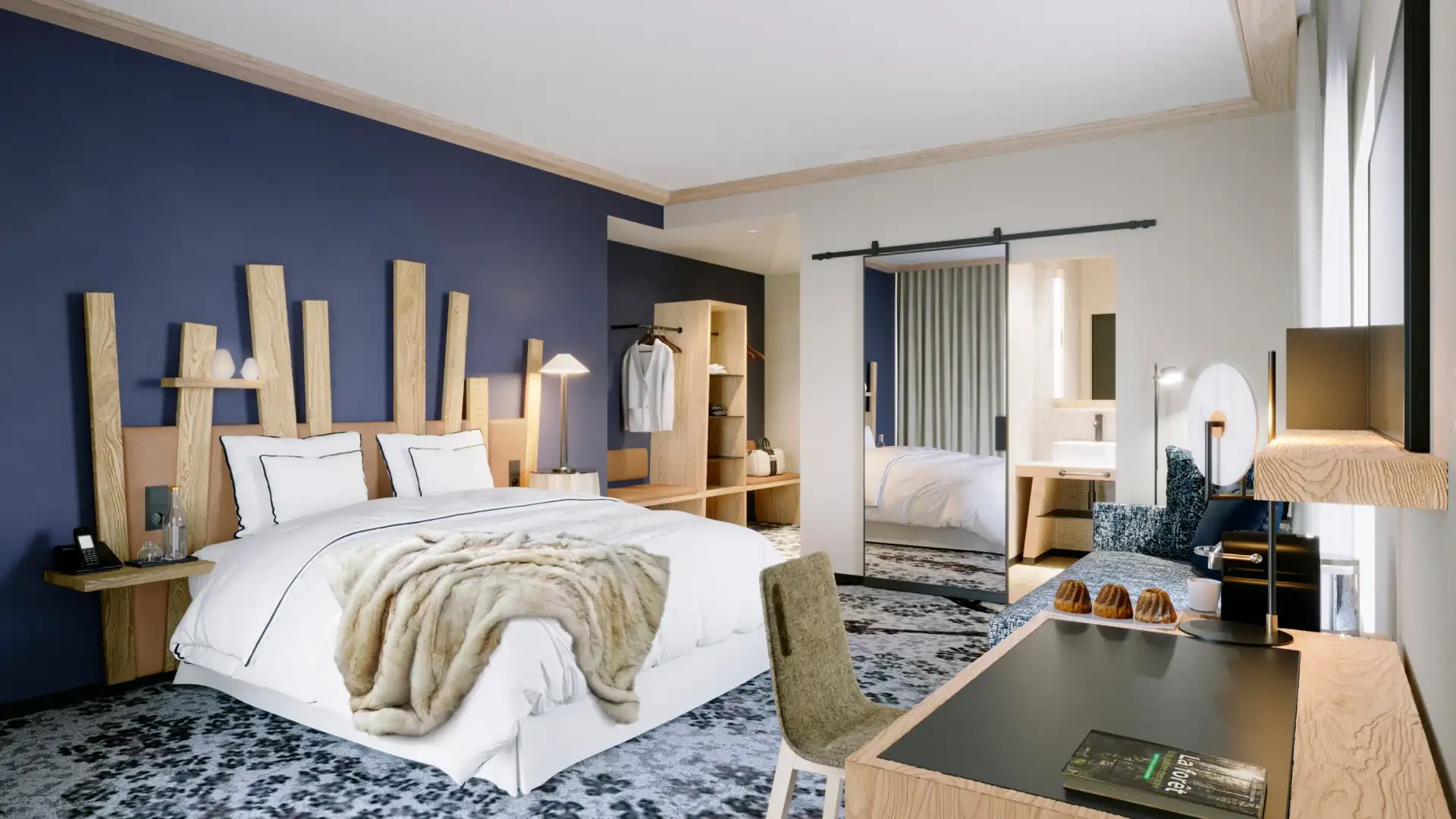 Chambre moderne avec un lit double, une table de chevet, un bureau et une armoire visible à travers une porte ouverte