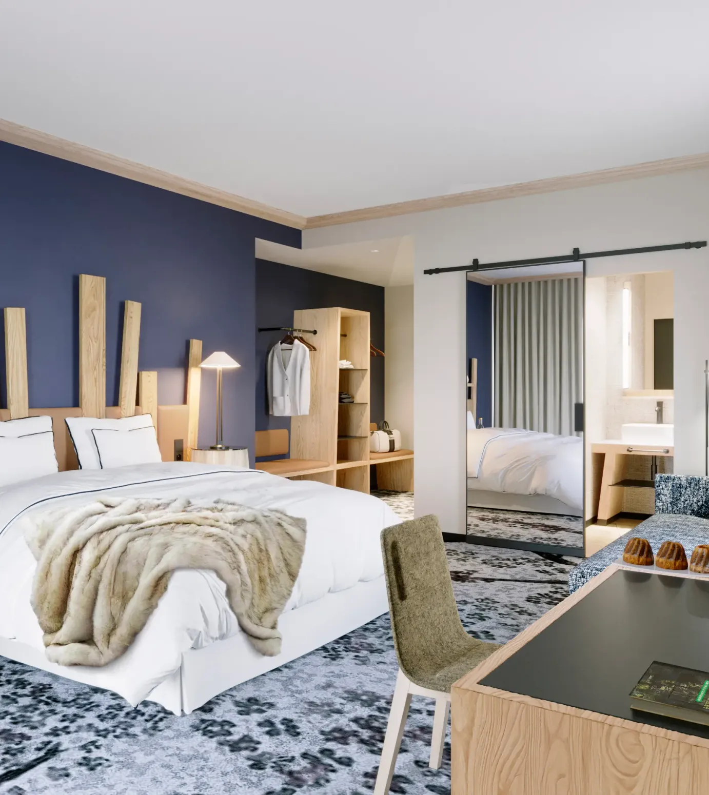 Chambre moderne avec un lit double, une table de chevet, un bureau et une armoire visible à travers une porte ouverte